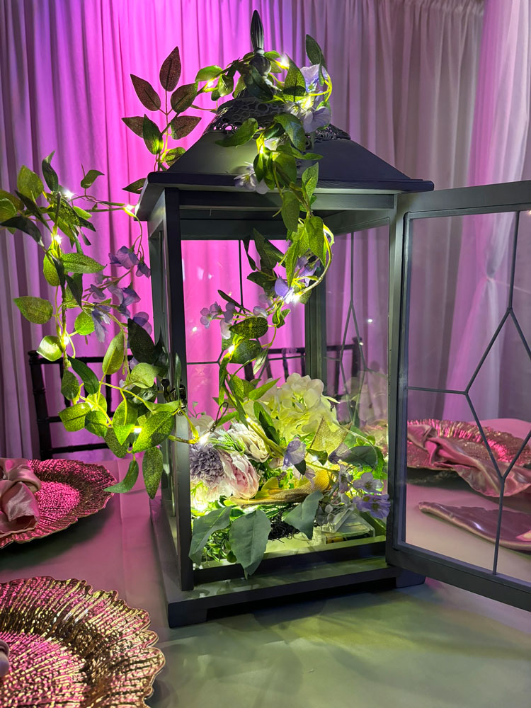 Butterflies-inspired lantern centerpiece with decorative butterfly details and twinkle lighting