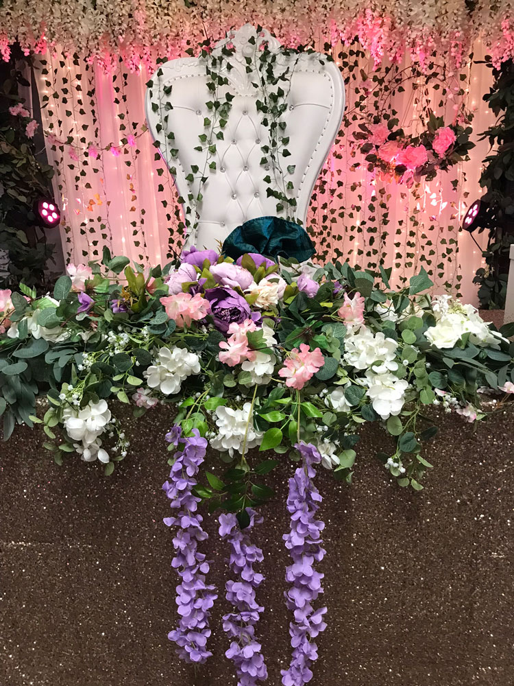 Honor table surrounded by greenery, candles, and forest-inspired décor