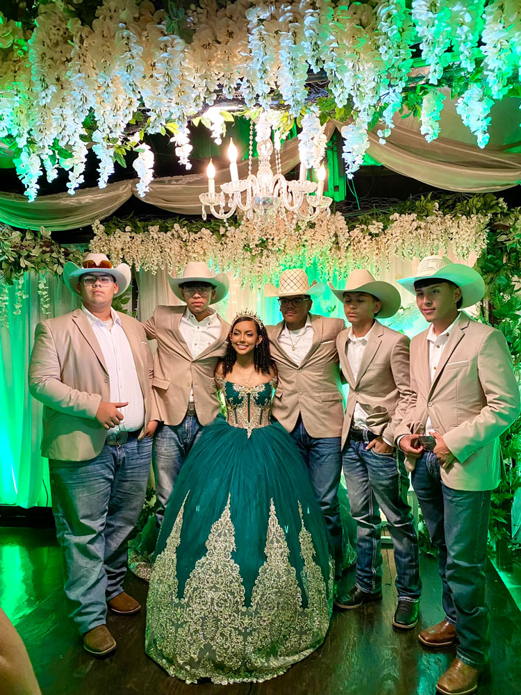 Quince girl with friends in celebration illuminated with emerald and sage tones