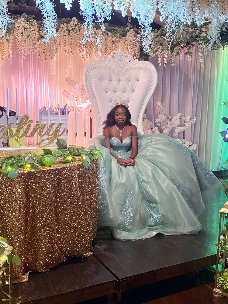 Quince girl at honor table styled in elegant shades of green