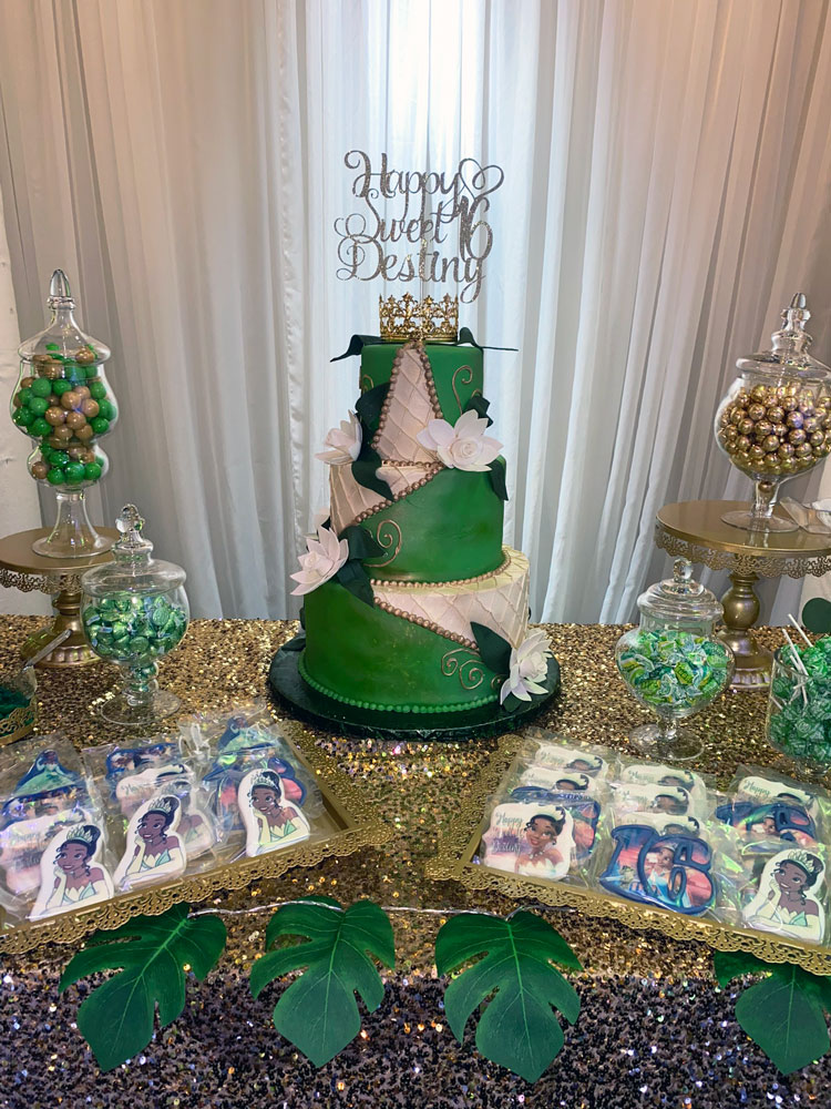 Cake table accented with greenery and soft green decor