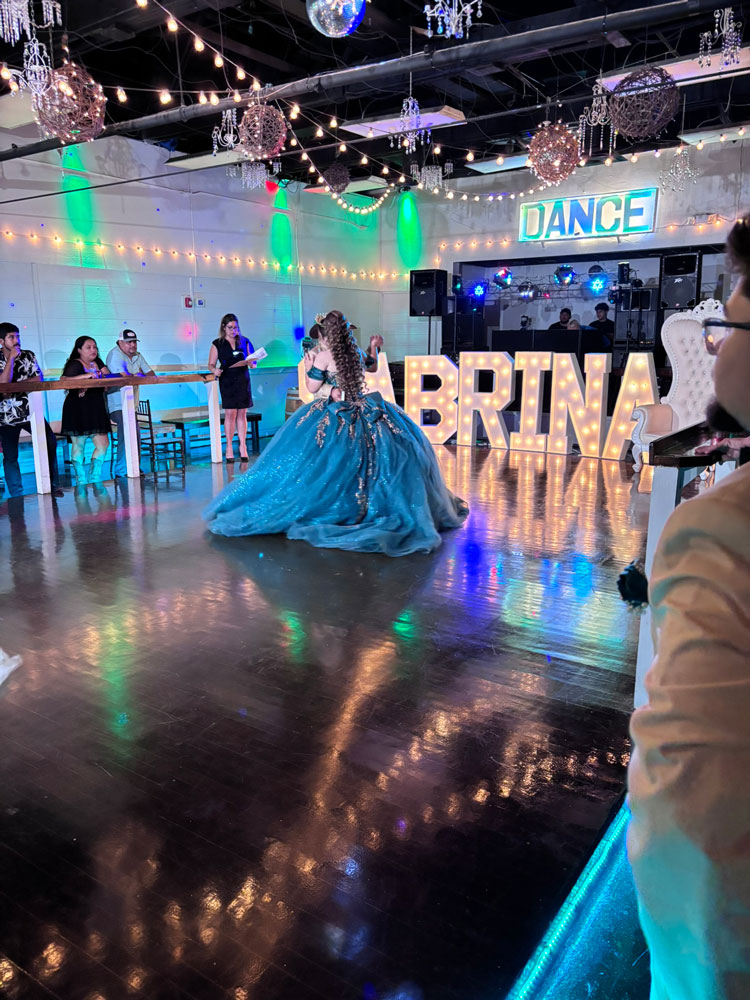 Quince girl in celebration with illuminated letters with emerald and sage tones