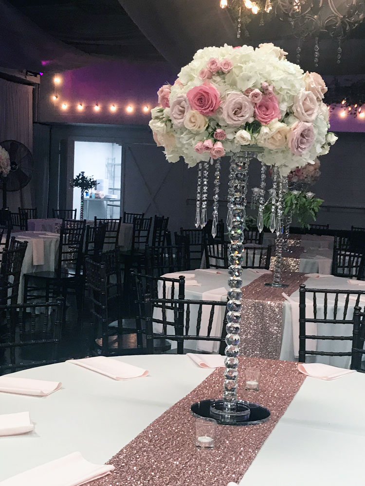 Romantic pink centerpiece with flower ball and pink accents designed for an elegant reception
