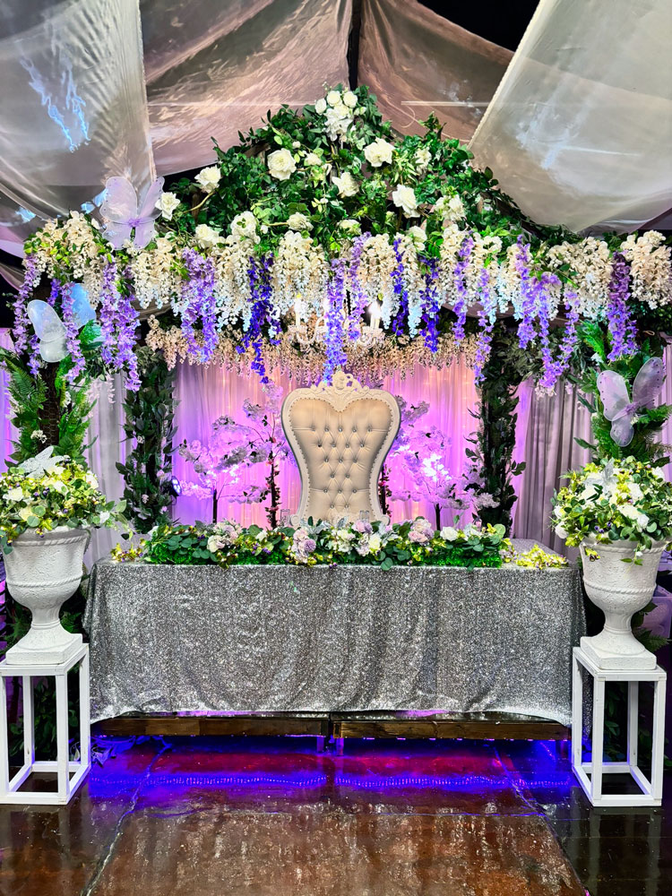 Formal head table featuring plum and lavender accents in the ballroom