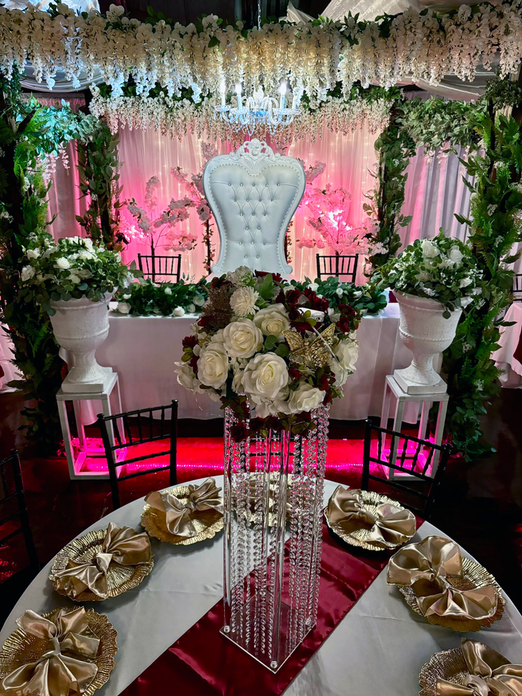 Elegant head table featuring crimson accents and beautiful lighting