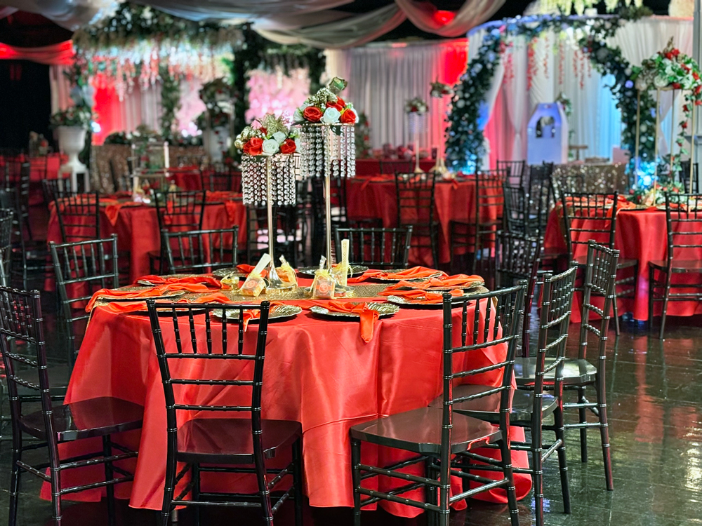 Tall jewelled table centerpiece in shades of crimson and burgundy