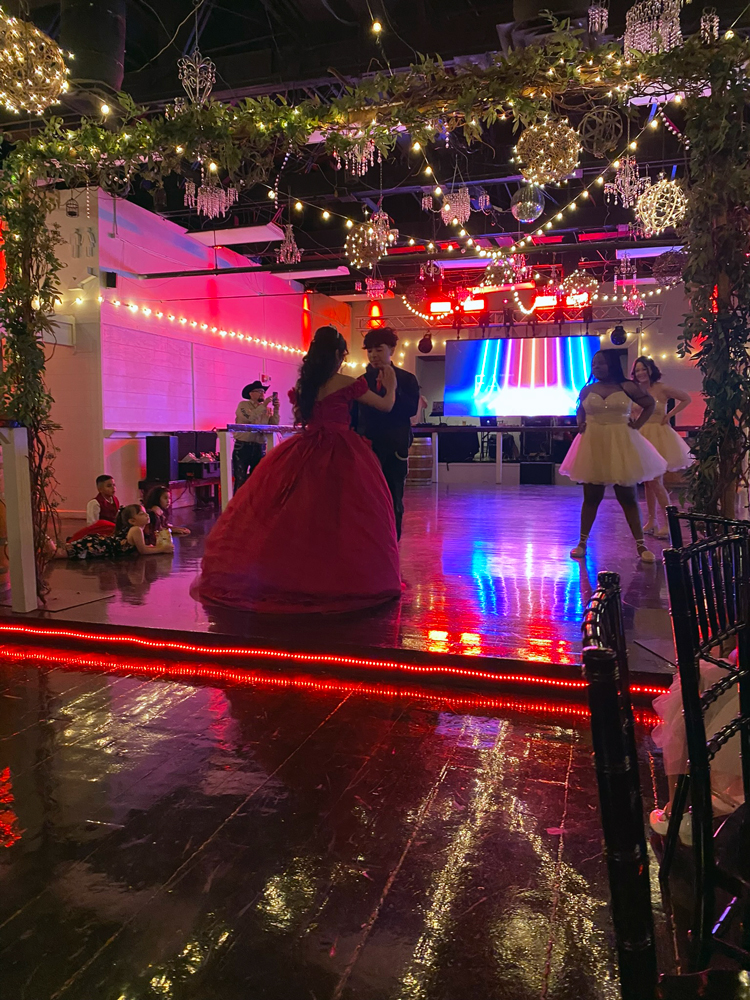 Father/daughter on dance floor with soft red uplighting creating a romantic atmosphere