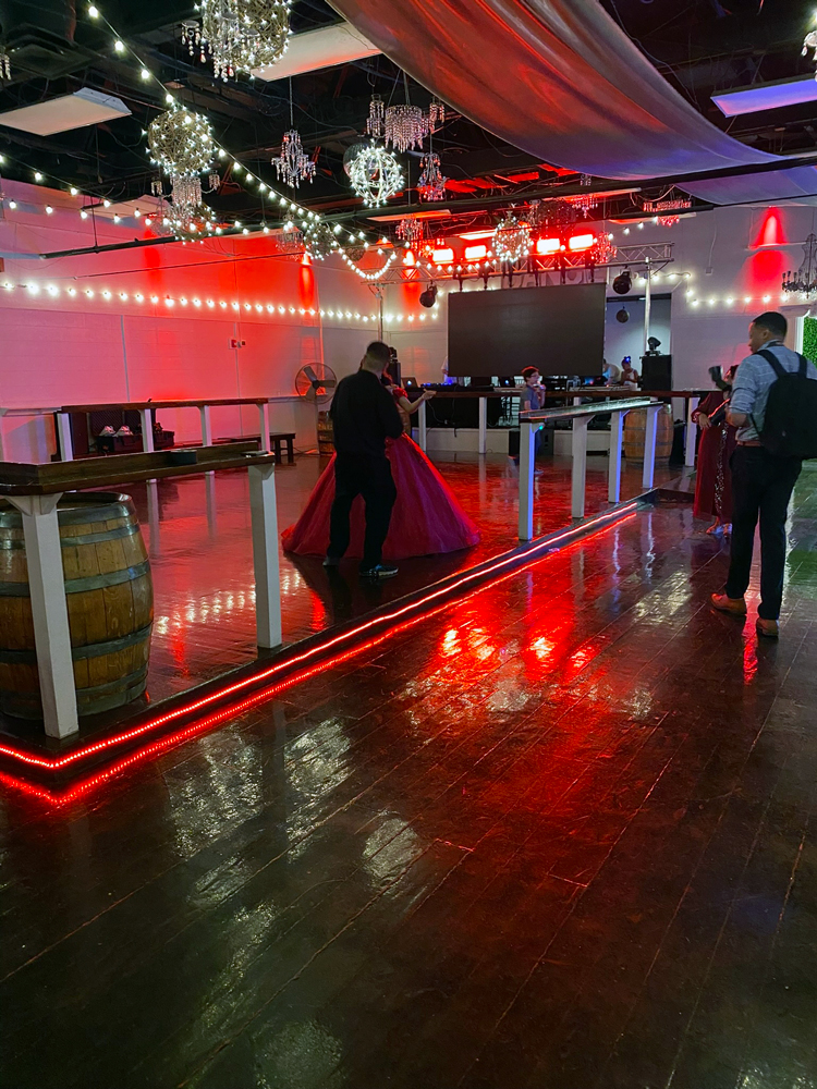 Illuminated dance floor with soft red uplighting creating a romantic atmosphere