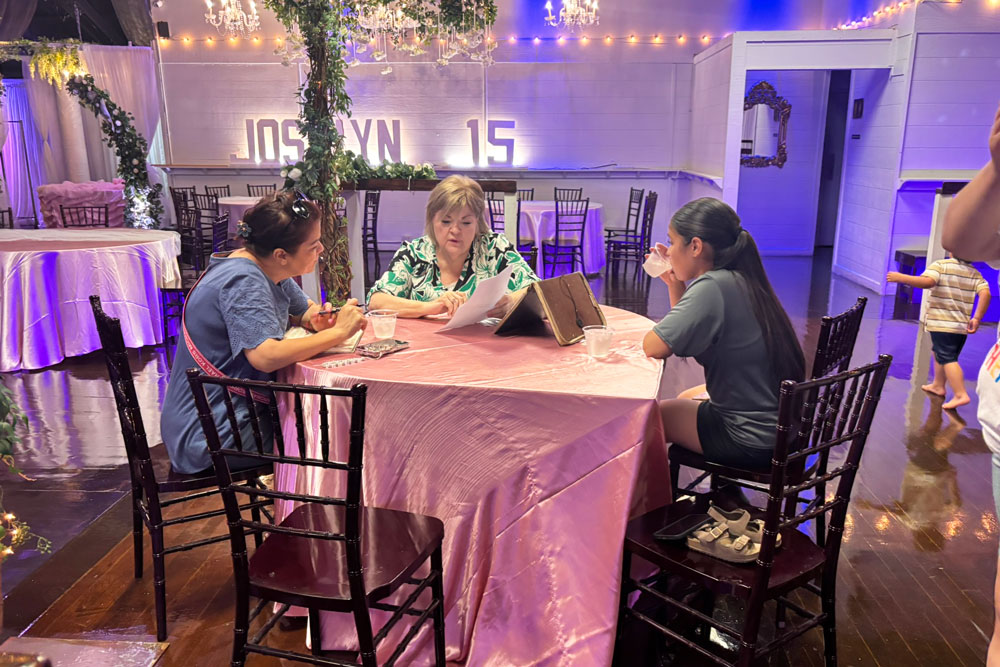 Clients meeting with salesperson to plan their quinceanera.