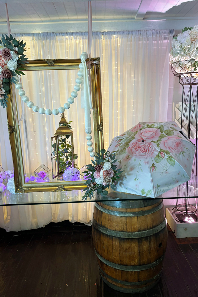 Suspended garden chandelier installation with greenery and lighting above event space