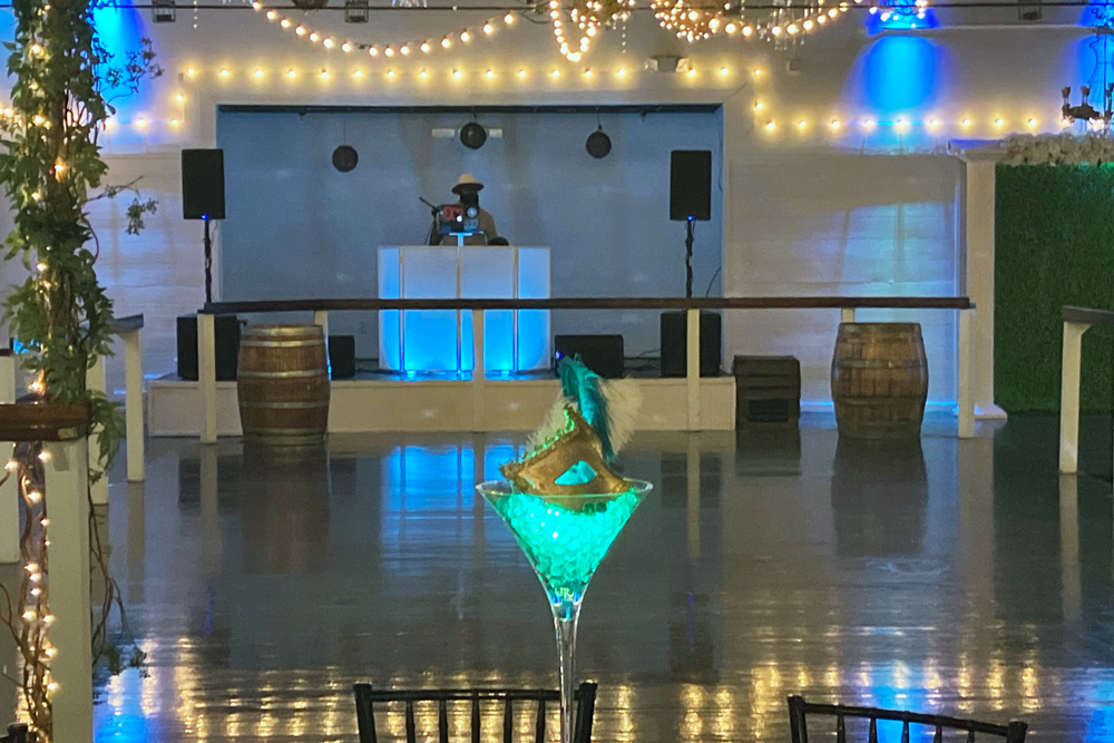 Illuminated dance floor wwith dj set up and ready to begin.