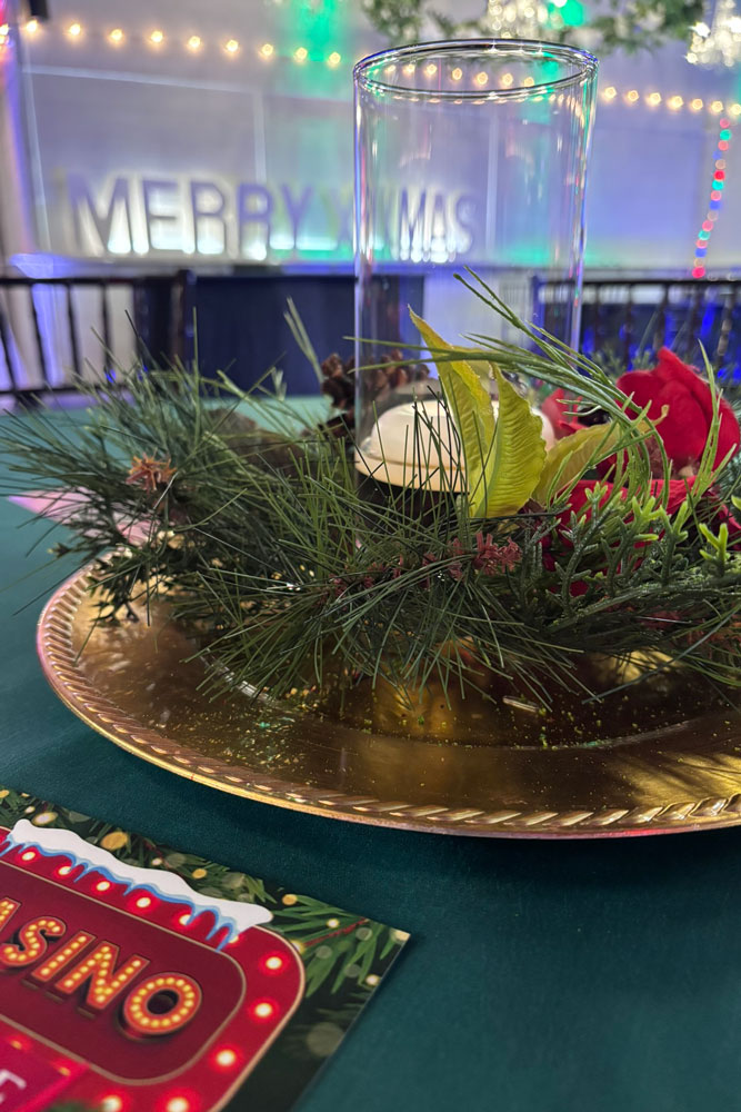 Christmas table setting with greenery, candles, and classic holiday centerpieces