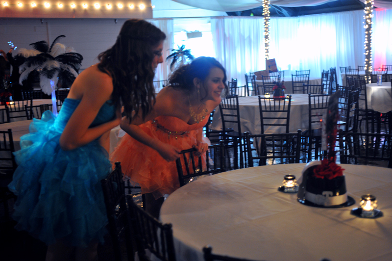 Two prom attendees admiring the centerpieces.