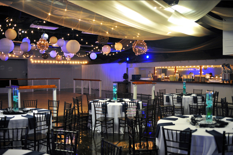 Prom ballroom set up with accent lighting.