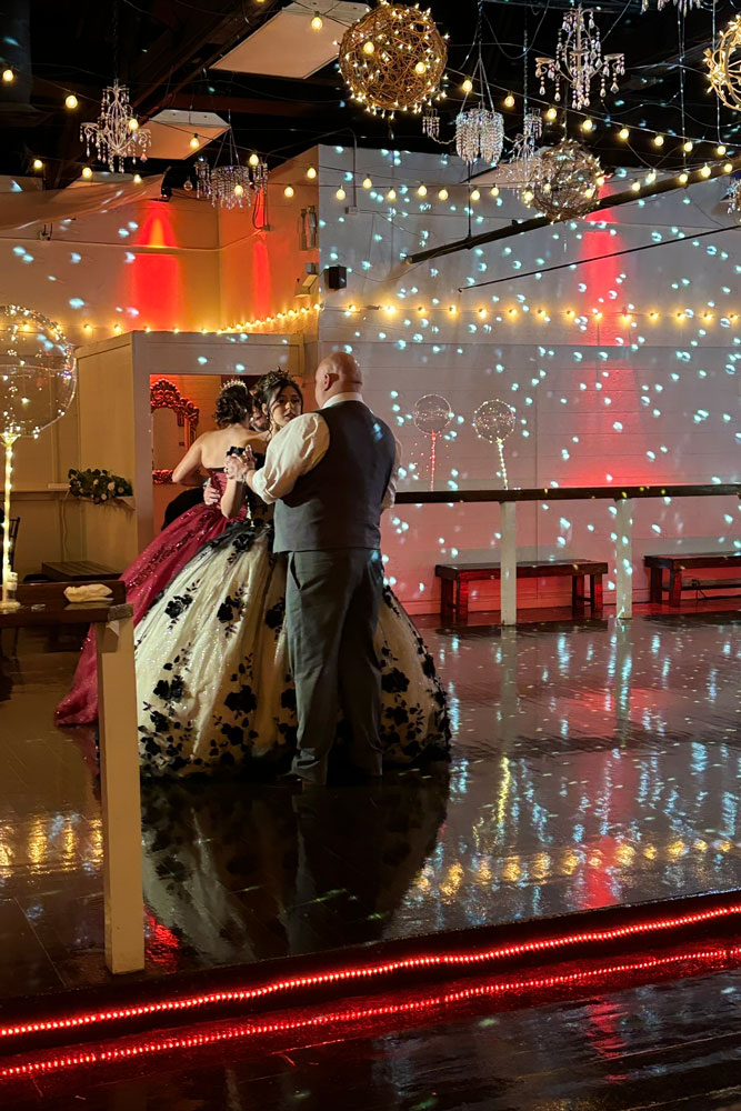 Father Daughter dancing on the illuminated dance floor.
