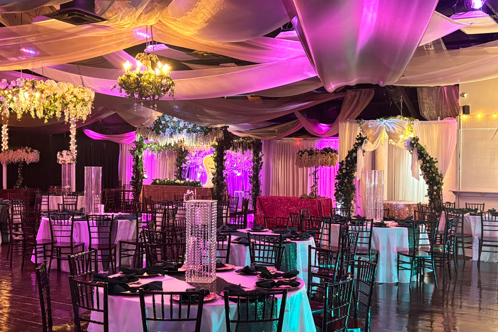 A look into the ballroom from the foyer with twinkling lights.