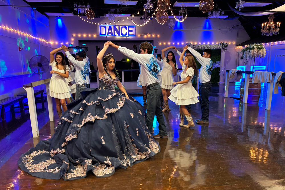 Special dance with court on illuminated dance floor.