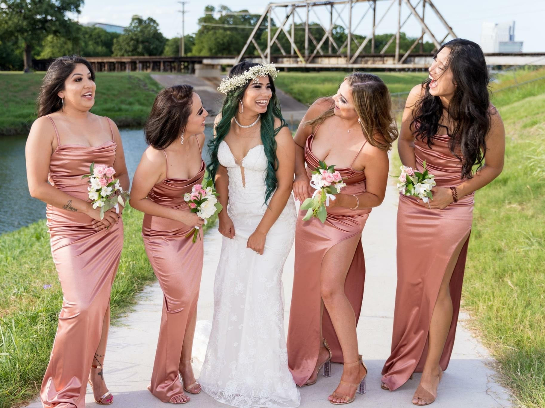 Bride with bridesmaids chatting outside prior to the ceremony.