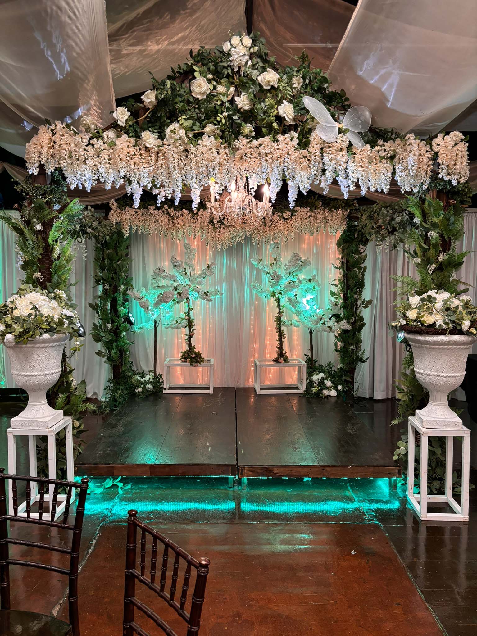 Greenery and floral garden gazebo ceremony area.