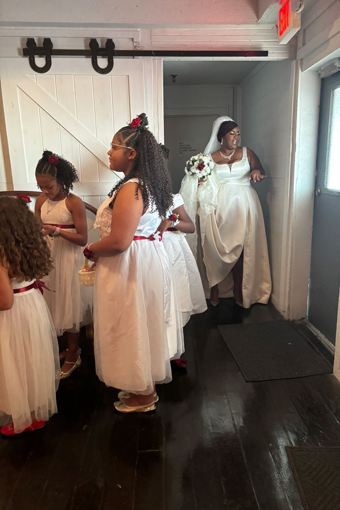 Bridesmaids anxiously waiting for the wedding ceremony to begin in the foyer.