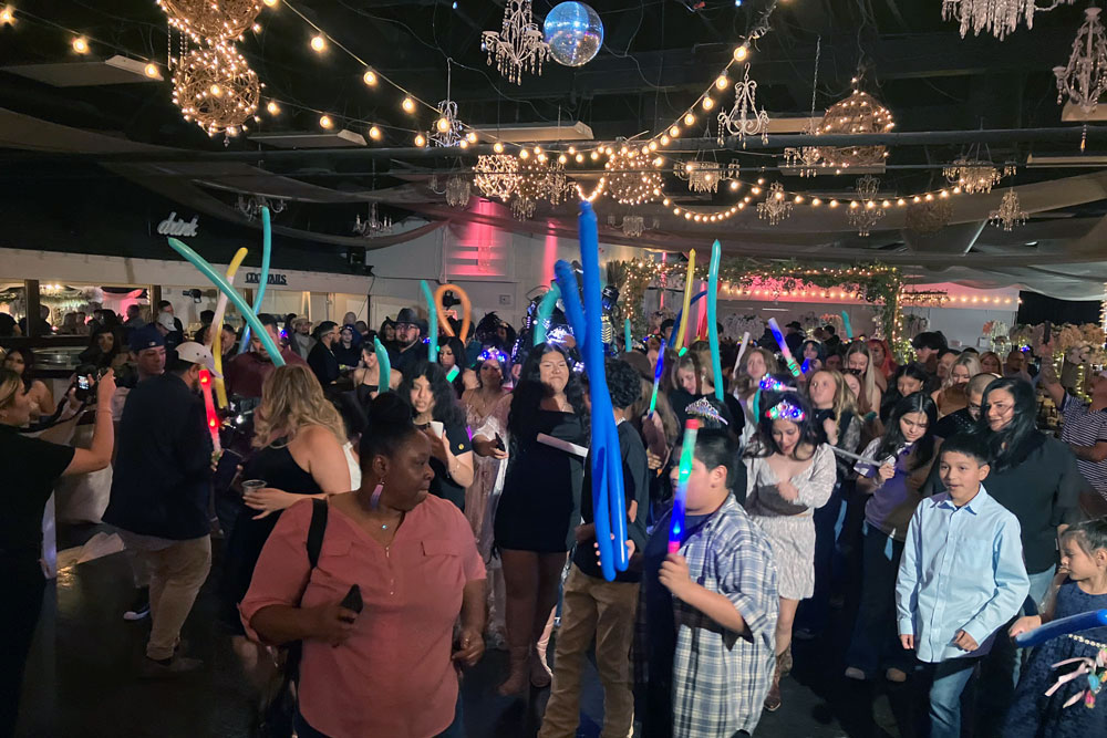 Spacious dance floor with elegant lighting and full guest participation