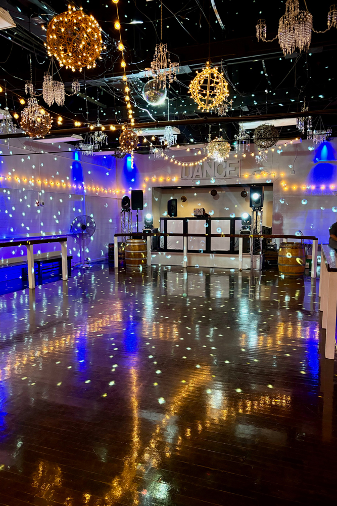 Smiling guests enjoying music and dancing in a lively space