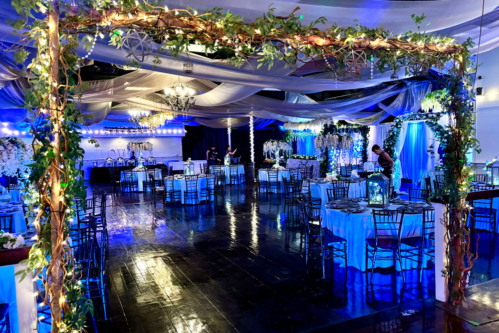 Decorated arch between the dance floor and guest area with blue accent lights.
