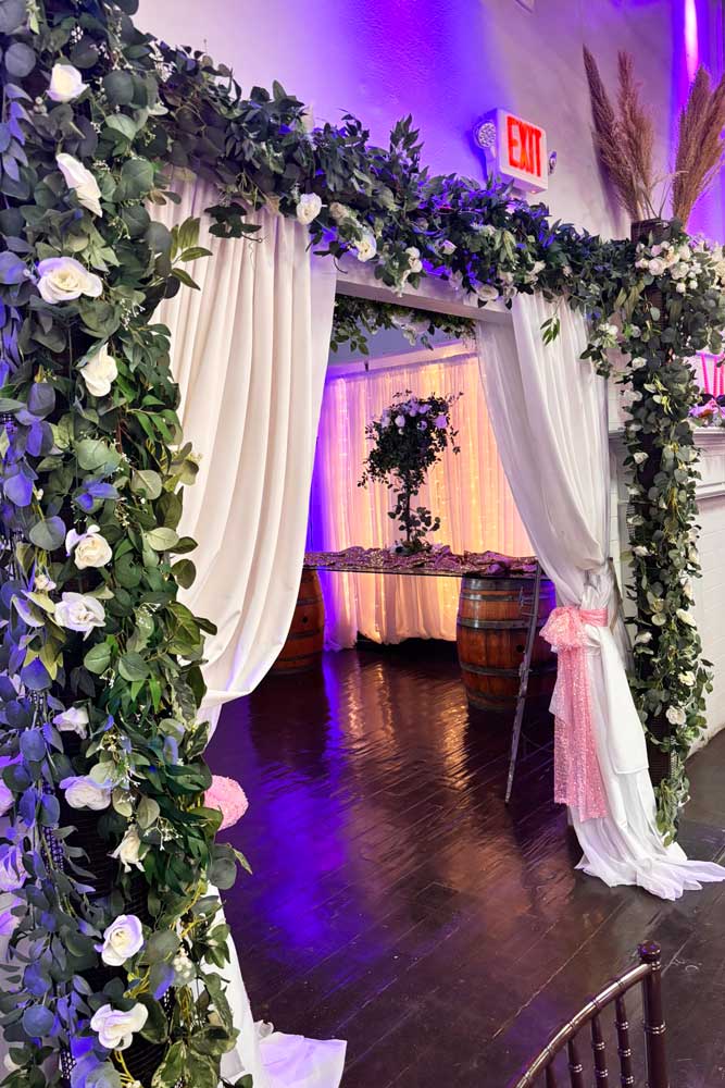Decorated room at a corporate event with tall centerpieces and decorative lighting
