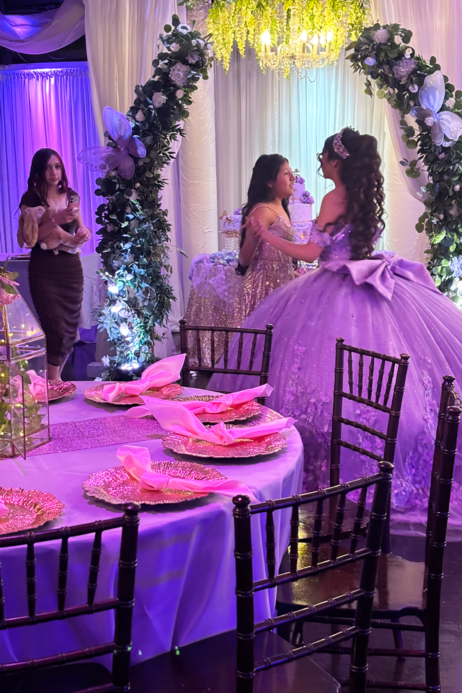 Quinceañer girl in dress with friends preparing for her grand celebration .