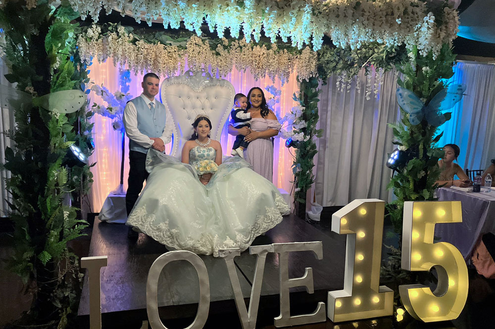 Decorated floral and greenery garden gazebo with chandelier that is a beautiful area for photos.