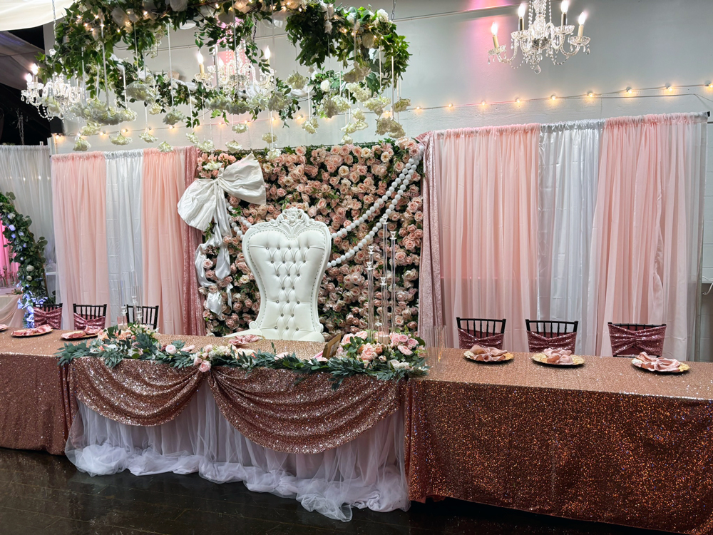 Garden chandelier styled above head table creating a dramatic focal point