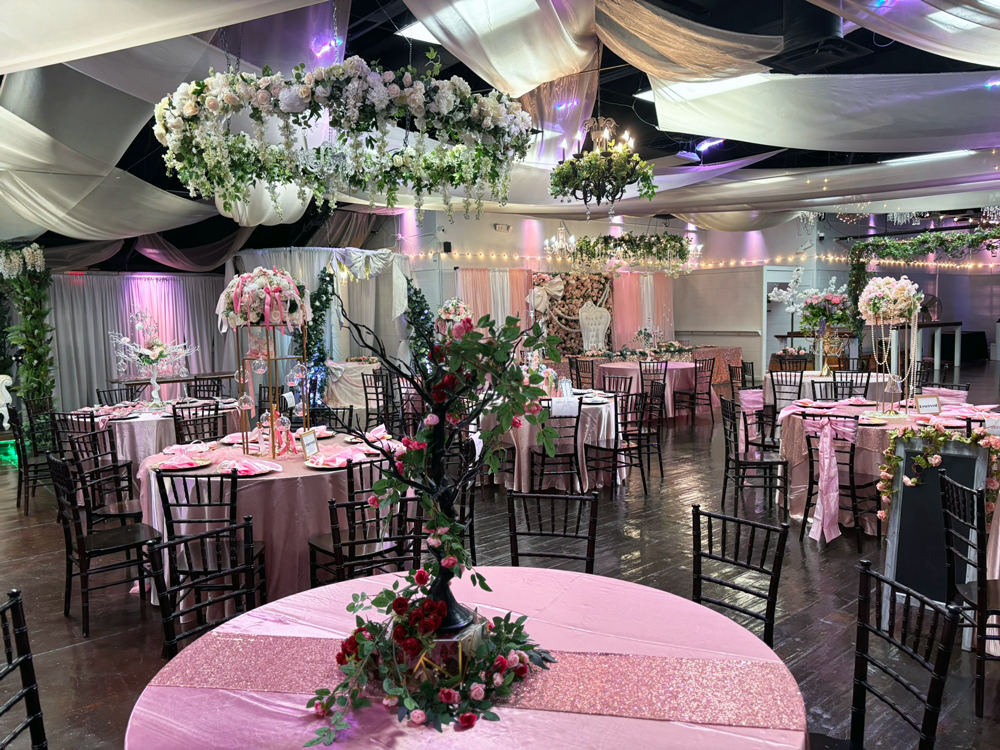 Suspended garden chandelier installation with greenery and lighting above event space