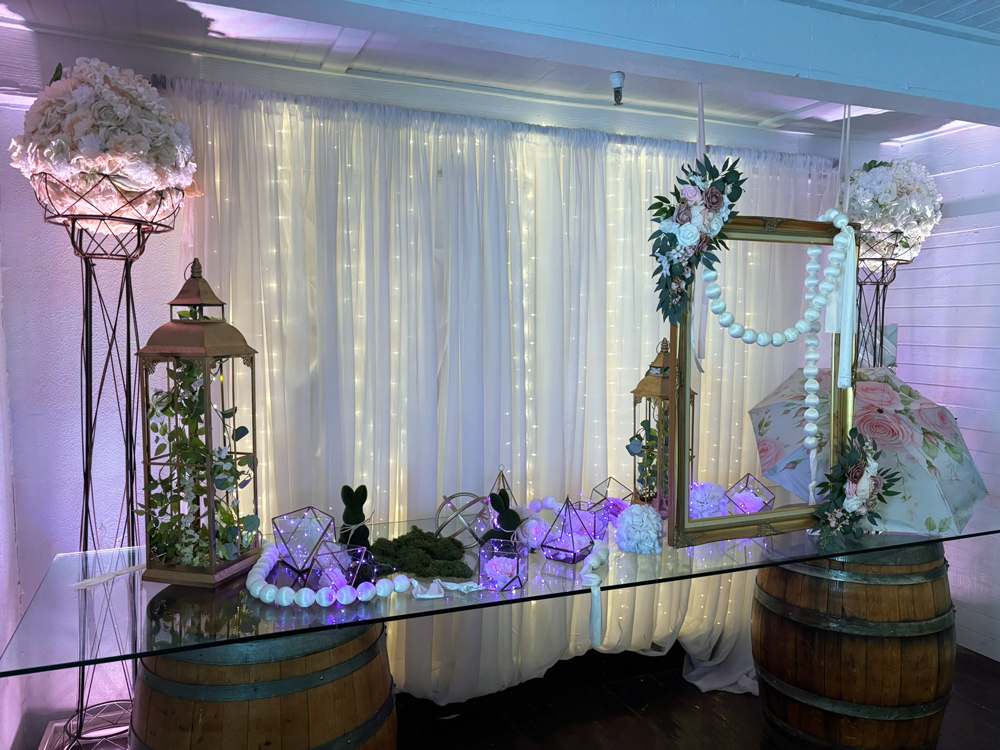 Welcome display table styled with decor for guest sign-in, gifts, or photos